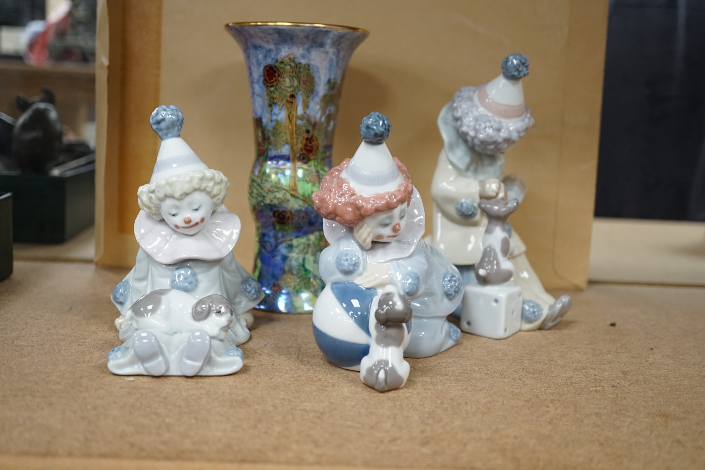 Three Lladro clowns and a Carlton ware dragon and cloud pattern vase, stamped to the base, largest 16cm high. Condition - fair, a few small chips